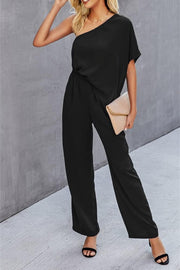 Black asymmetric one-shoulder wide-leg jumpsuit with drape sleeves and elastic waist