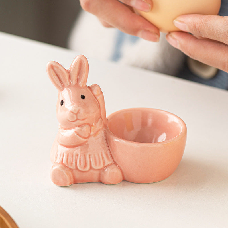 Ceramic bunny egg holder in blush pink with a cute bow detail.