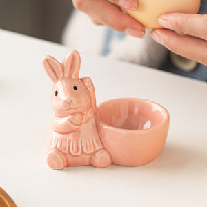 Ceramic bunny egg holder in blush pink with a cute bow detail.