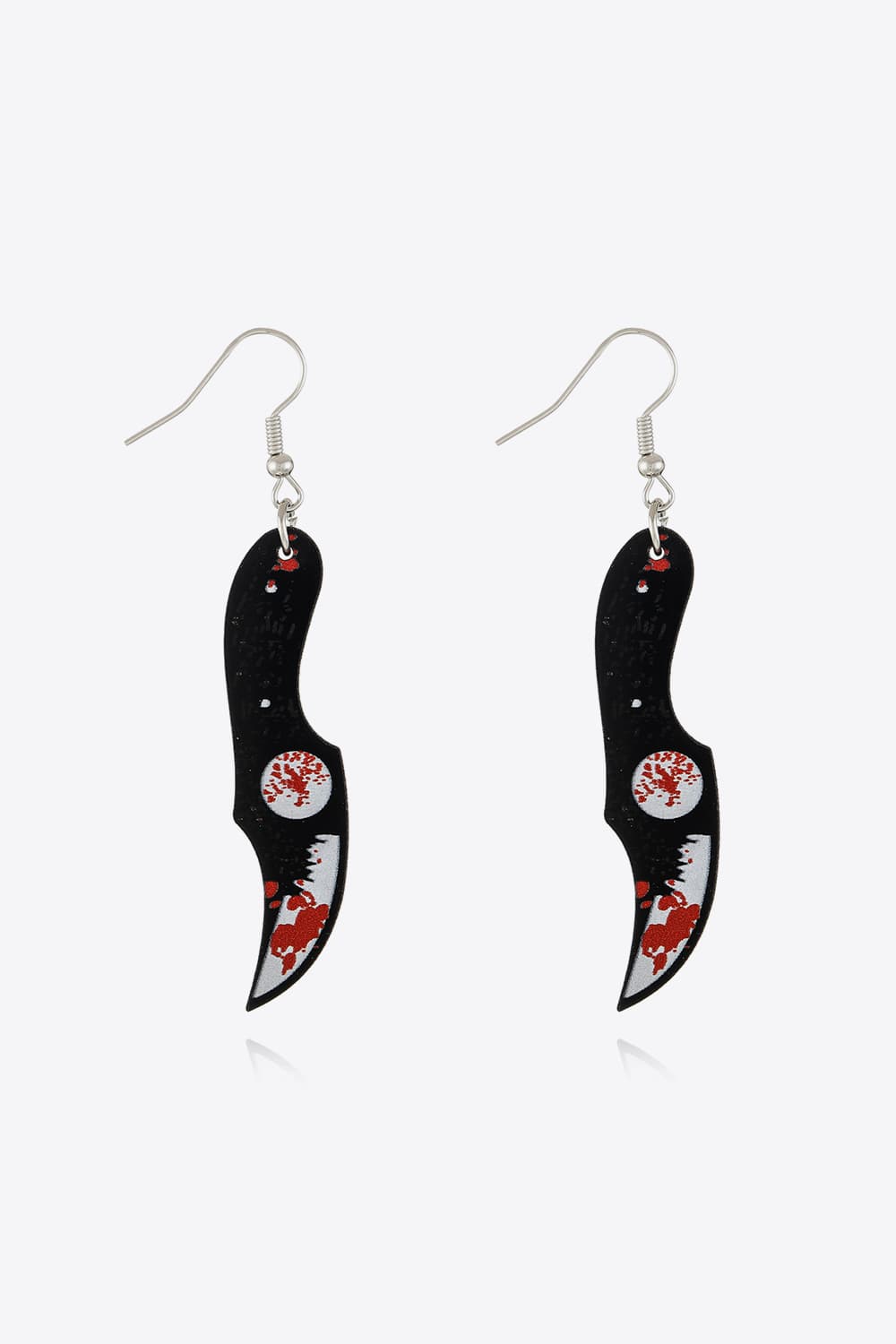 Gory blade drop earrings with red splatters and a white circular detail.