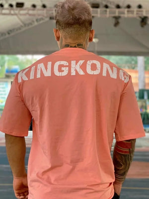Oversized burnt coral t-shirt with white KINGKONG graphic on back.