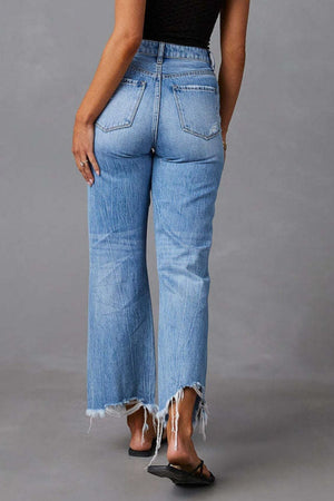 Light blue distressed flare jeans with raw frayed hemline