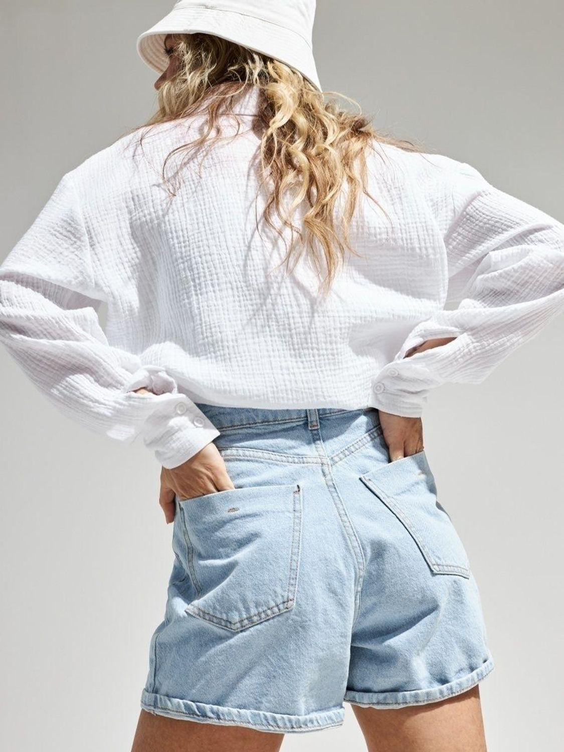 White textured cotton overshirt with relaxed fit and button cuffs.