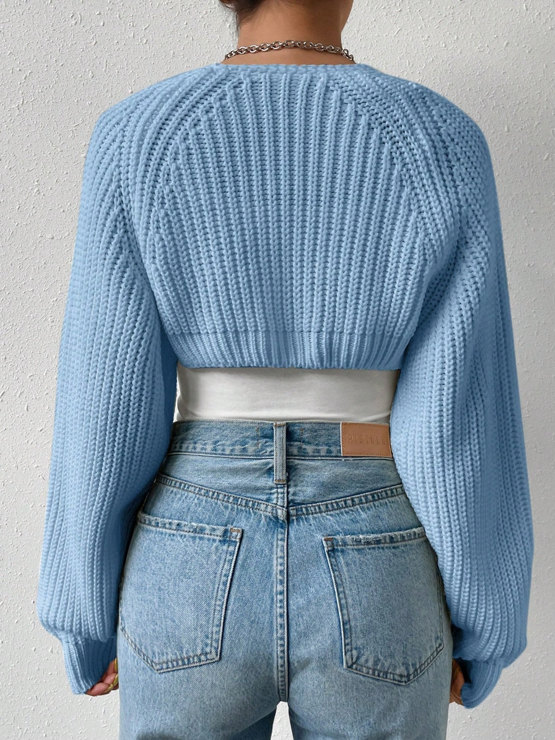 Light blue cropped knit bolero shrug with balloon sleeves and ribbed texture.