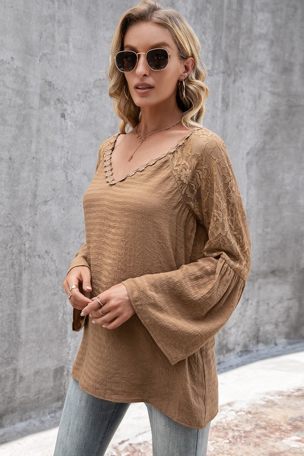Camel blouse with lace sleeves and scallop trim neckline.