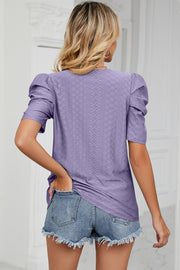 Perforated puff sleeve top in lavender with textured diamond pattern and short sleeves.
