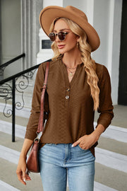Brown textured henley blouse with button detail and v-neck.
