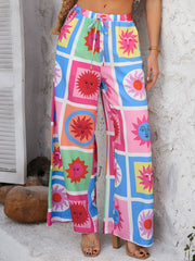 Geometric print wide-leg trousers with drawstring waist in multicolor sun pattern.