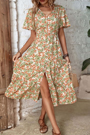 Flutter sleeve floral midi dress with v-neck, button front, tiered skirt and thigh slit.