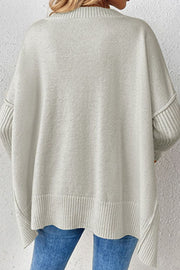 Gray V-neck knit sweater with ribbed cuffs and asymmetric hemline