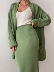 Ribbed knit co-ord set in Gum Leaf green, featuring a long cardigan with pockets and a midi skirt.