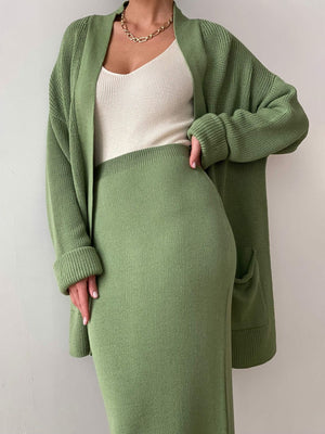 Ribbed knit co-ord set in Gum Leaf green, featuring a long cardigan with pockets and a midi skirt.