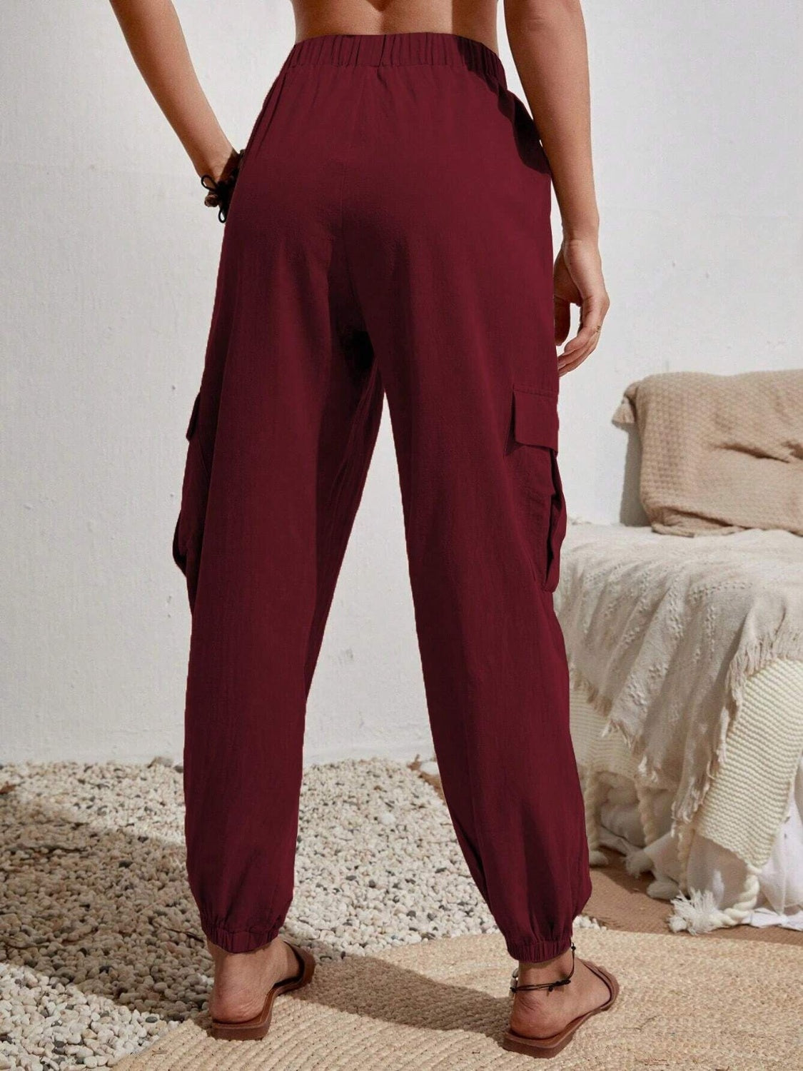 Burgundy textured cargo lounge trousers with elastic cuffs and side pockets.