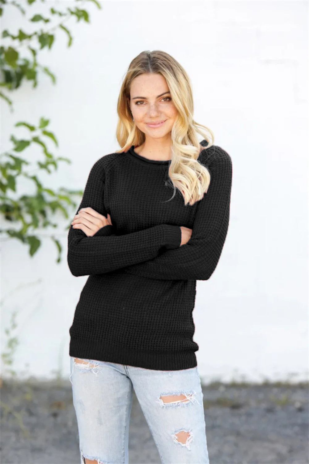 Black honeycomb knit raglan pullover sweater with crew neck and long sleeves.