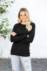 Black honeycomb knit raglan pullover sweater with crew neck and long sleeves.