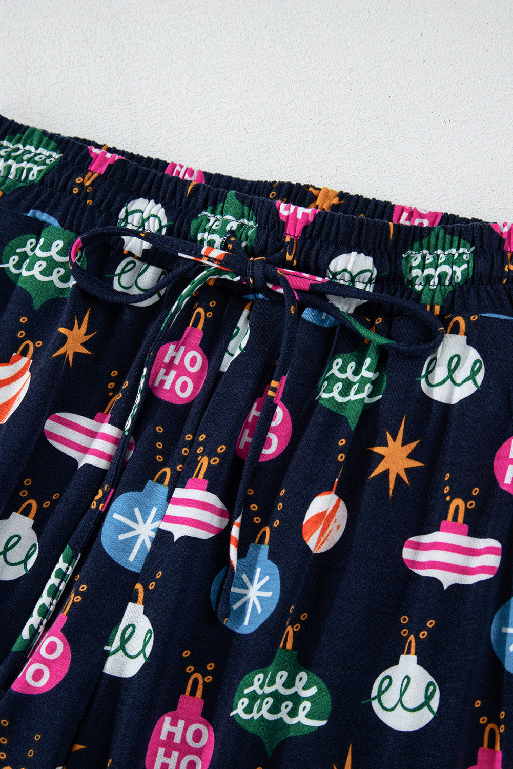 Navy blue lounge pants with festive bauble print and drawstring waist.