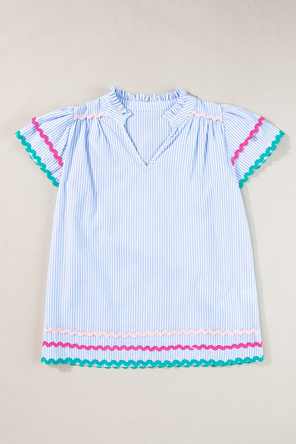 Light blue striped blouse with ruffled neckline and scalloped trim sleeves and hem.