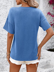 Blue ribbed V-neck t-shirt with short sleeves and a pocket detail.