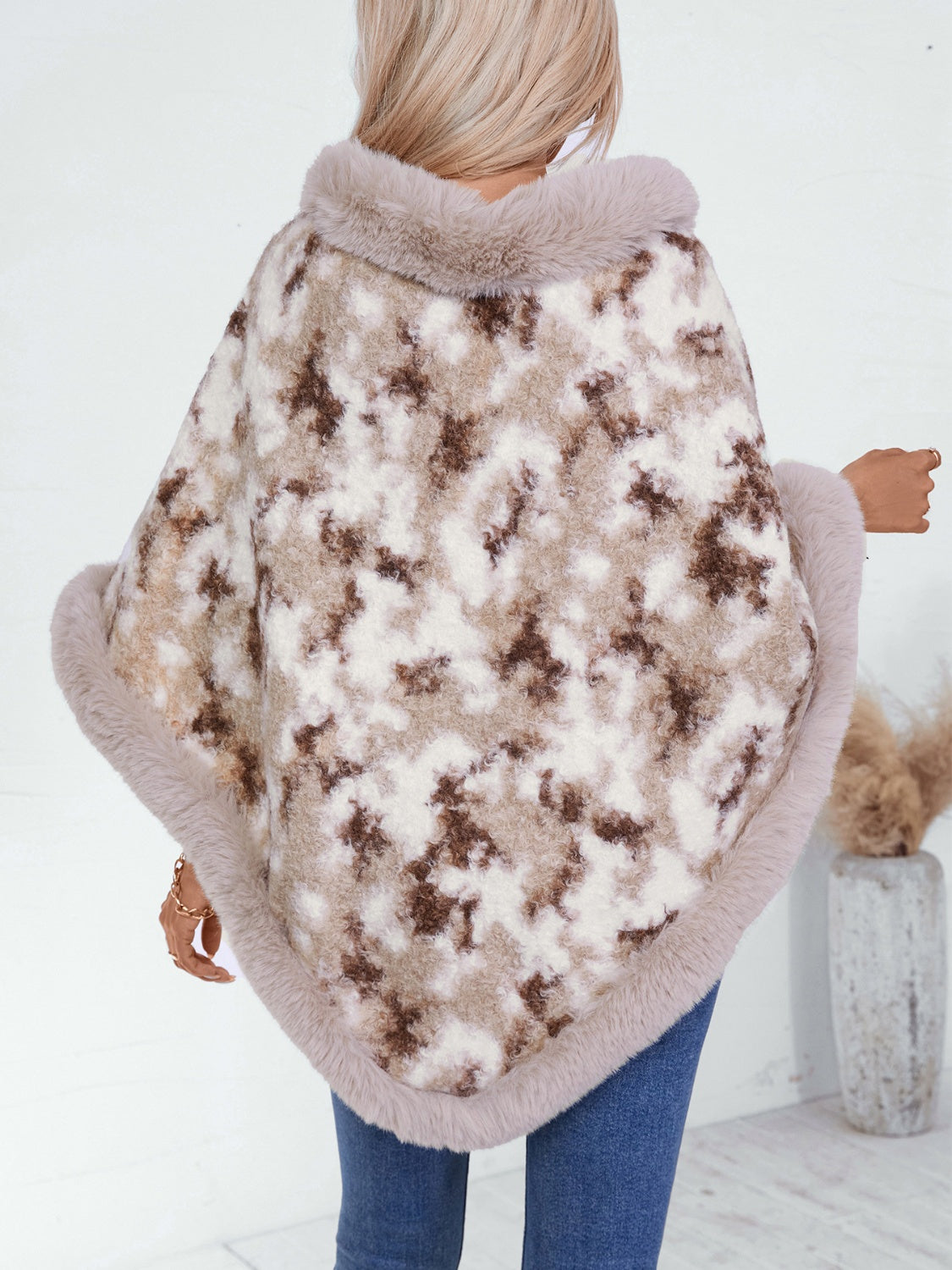 Faux fur trimmed camo poncho in Chocolate with a fuzzy texture and plush trim.