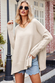 Oversized tan ribbed knit sweater with V-neck and slit hem