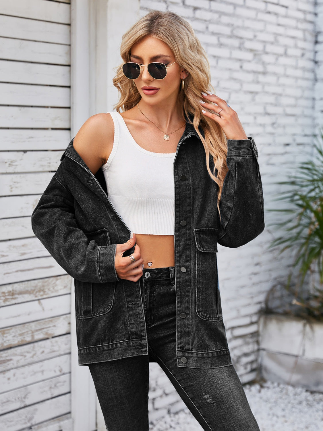 Black denim button-up jacket with chest pockets and a relaxed fit.