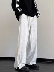 Men's light gray relaxed fit sweatpants with drawstring and zippered leg openings.