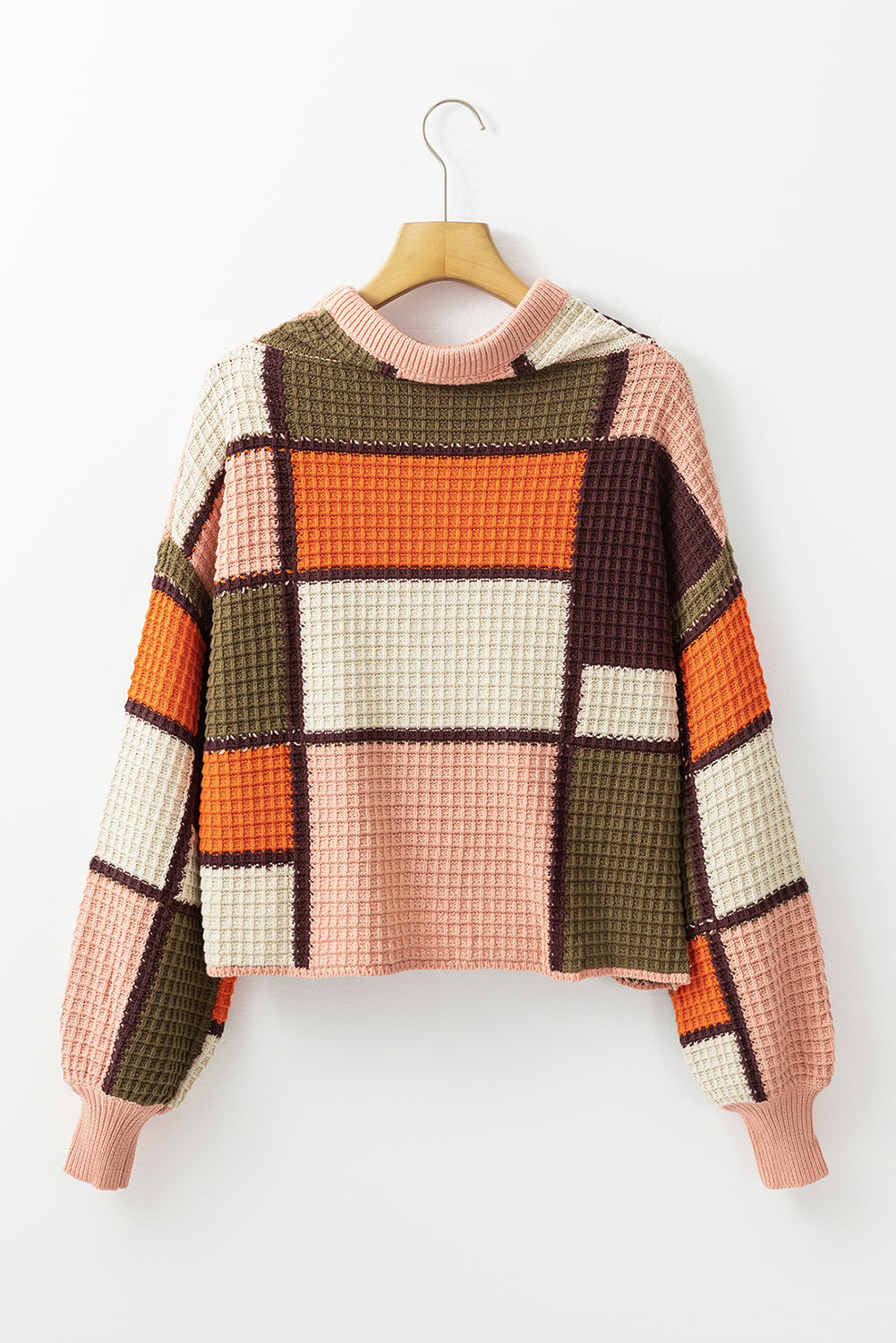 Waffle knit patchwork hoodie in orange, pink, cream, olive green, and brown with a relaxed fit.