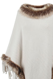 Ivory textured knit poncho with faux fur trim and fringe detail