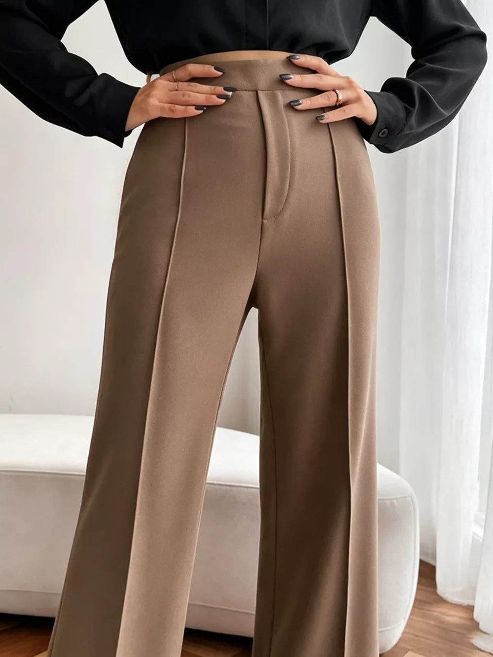 Brown high-waisted flare maternity pants with front seams and a relaxed fit.