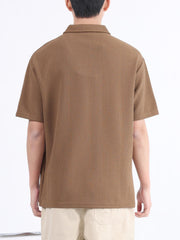 Desert Color textured polo shirt with short sleeves and a collared neckline.