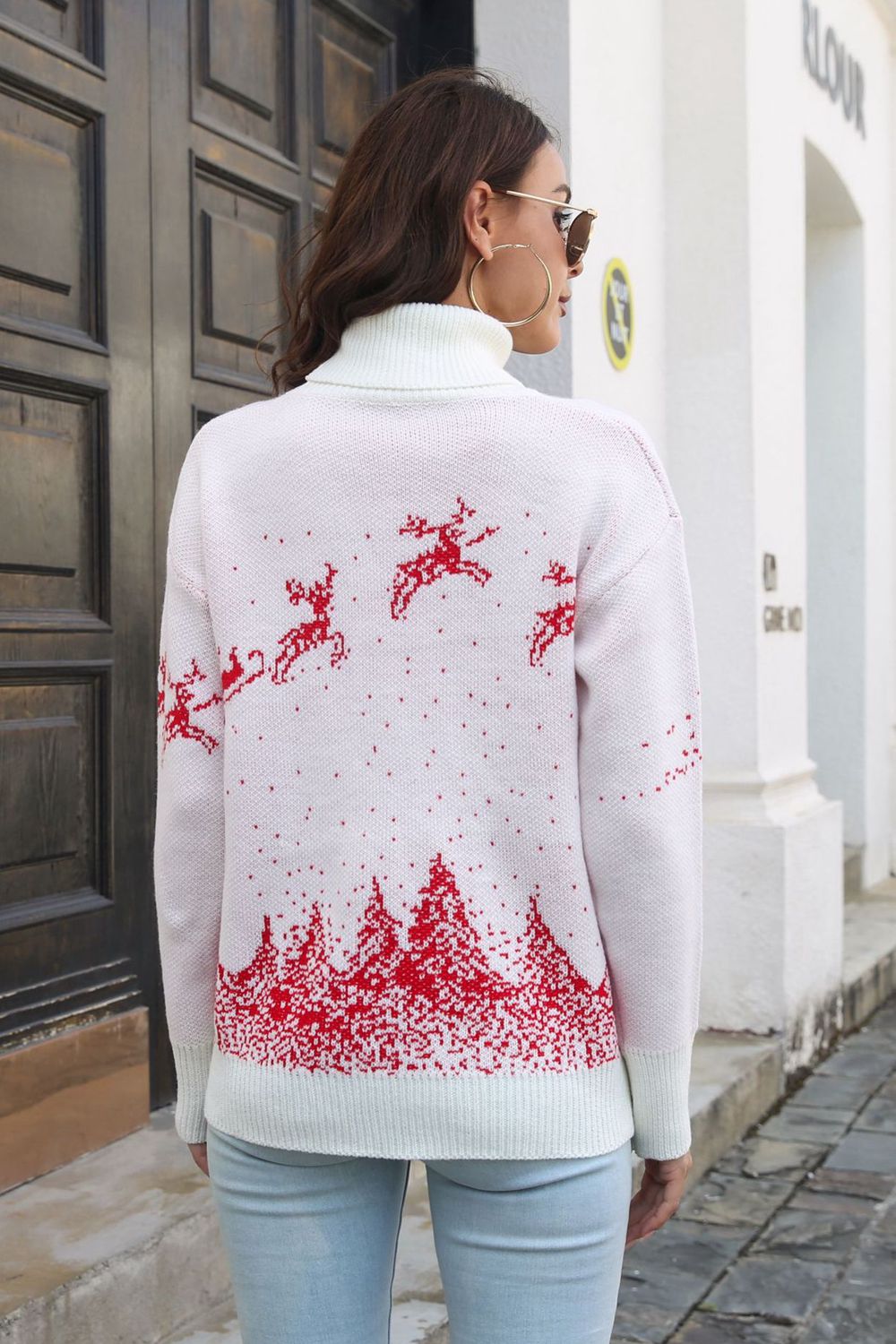 White turtleneck sweater with red reindeer and forest pattern