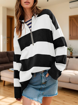 Oversized black and white striped zip-up pullover with a collared neckline.