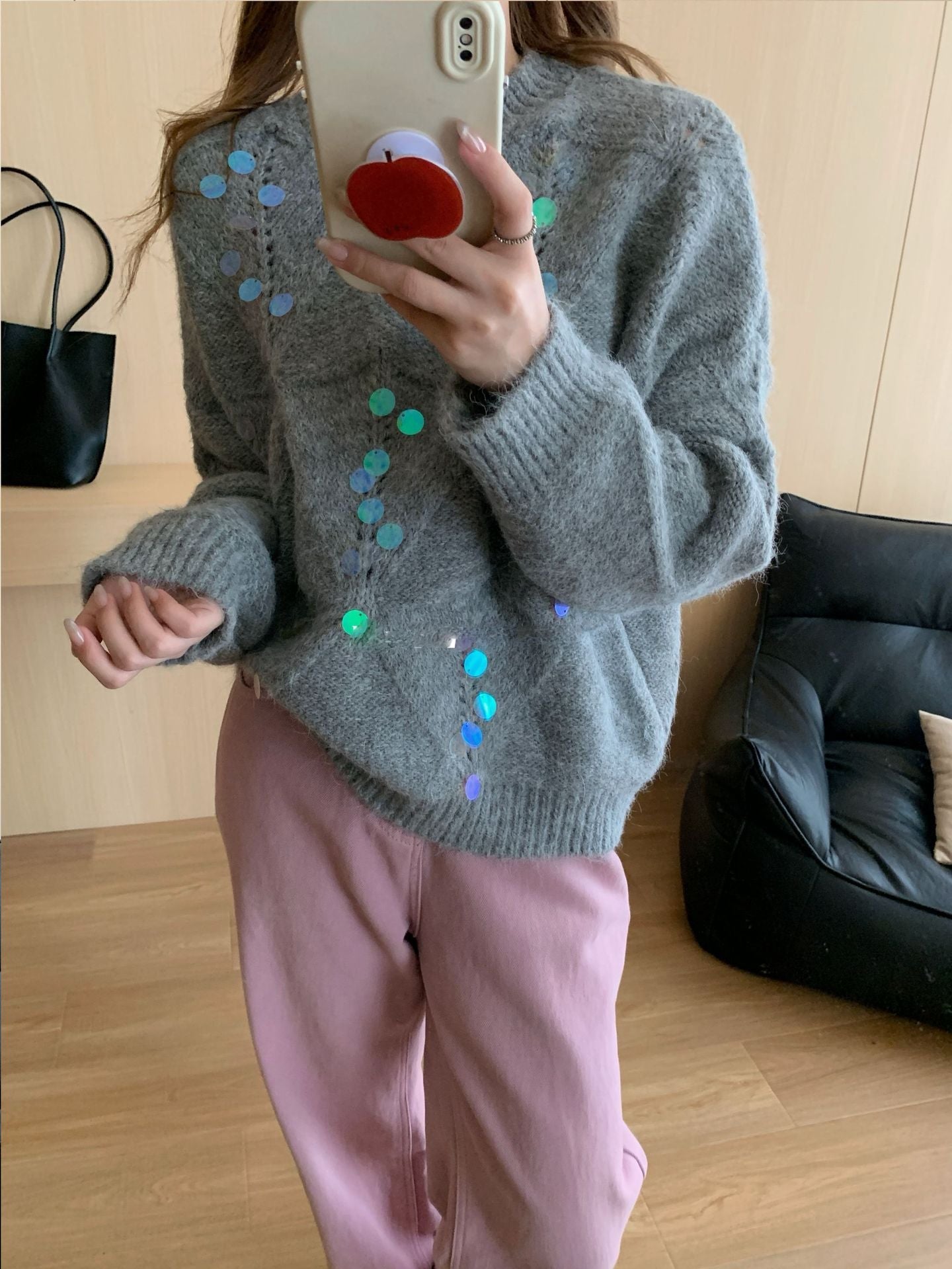 Gray diamond knit sweater with scattered iridescent sequins and a crew neck.