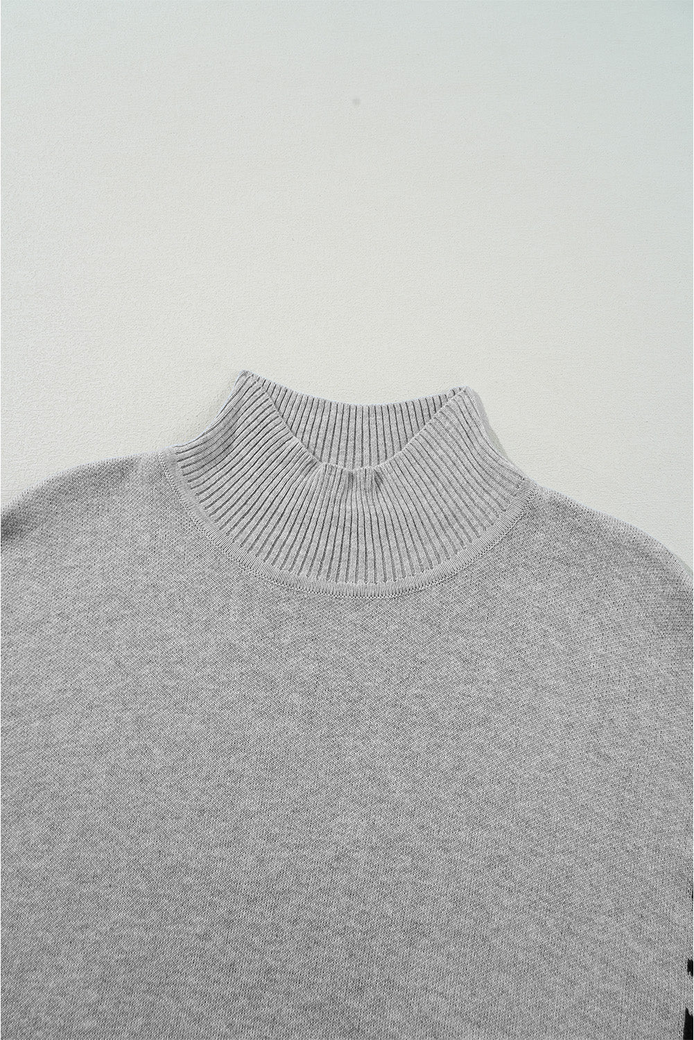 Gray acrylic knit sweater with mock neck and asymmetric leopard panel detail.