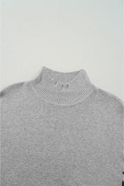 Gray acrylic knit sweater with mock neck and asymmetric leopard panel detail.