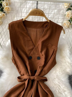 Brown V-neck sleeveless wide leg jumpsuit with double-breasted buttons and tie belt.
