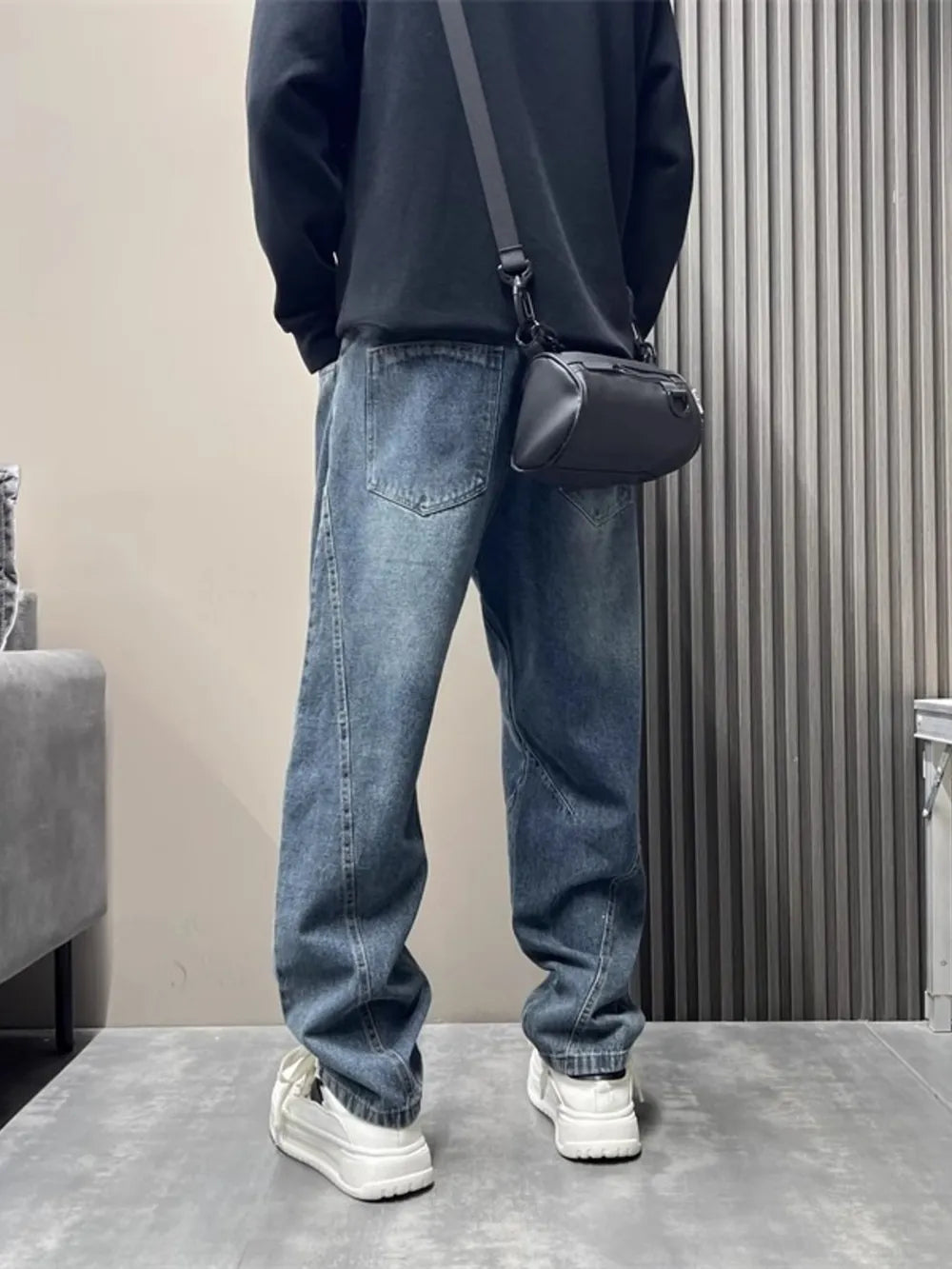 Men's blue washed oversized jeans with tapered cuffs and a relaxed fit.
