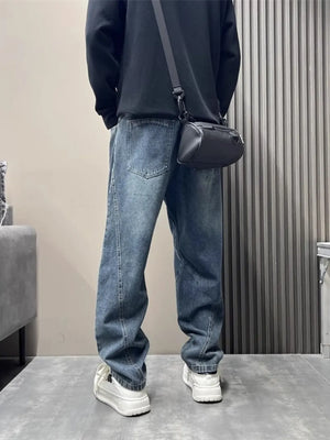 Men's blue washed oversized jeans with tapered cuffs and a relaxed fit.