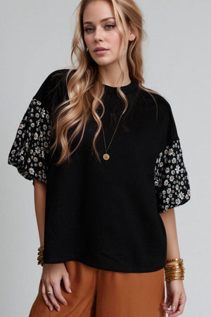 Black t-shirt with contrast daisy print sleeves and crew neck