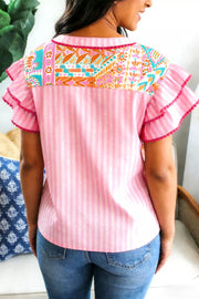 Pink striped polyester blouse with vibrant patchwork yoke and ruffled sleeves.