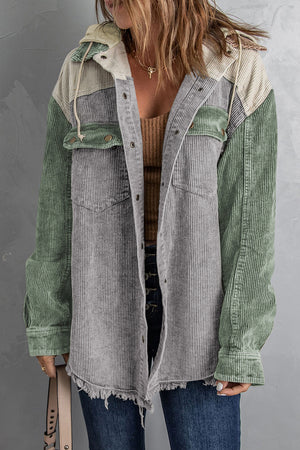 Colorblock corduroy hooded utility jacket in green and gray with frayed hem.