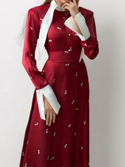 Burgundy midi dress with contrast collar, defined waist, and white floral print.