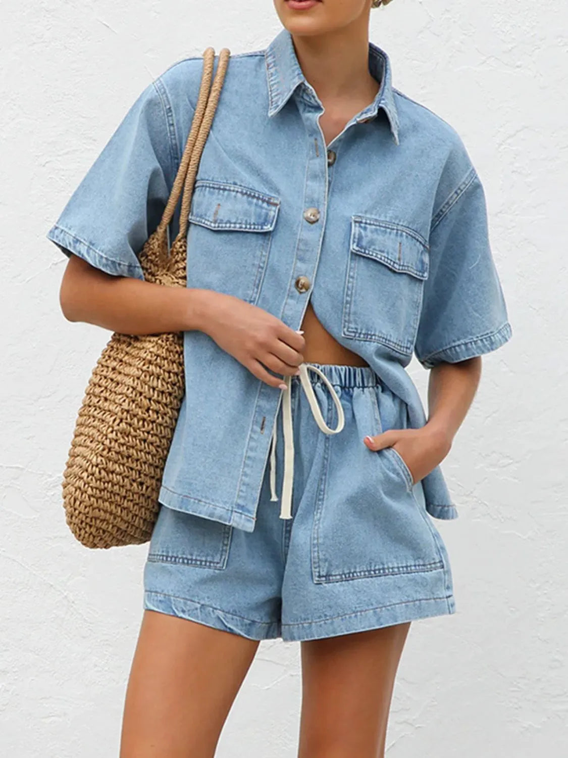 Light wash denim co-ord set with short sleeve button-up shirt and drawstring shorts.
