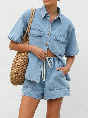 Light wash denim co-ord set with short sleeve button-up shirt and drawstring shorts.