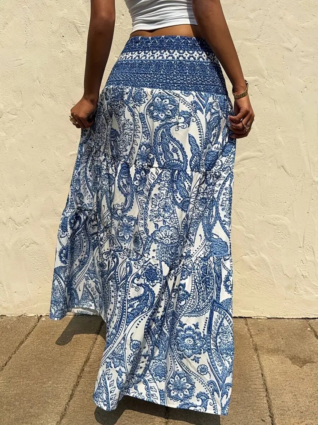 Bohemian paisley maxi skirt in blue with smocked waist and tiered ruffles.