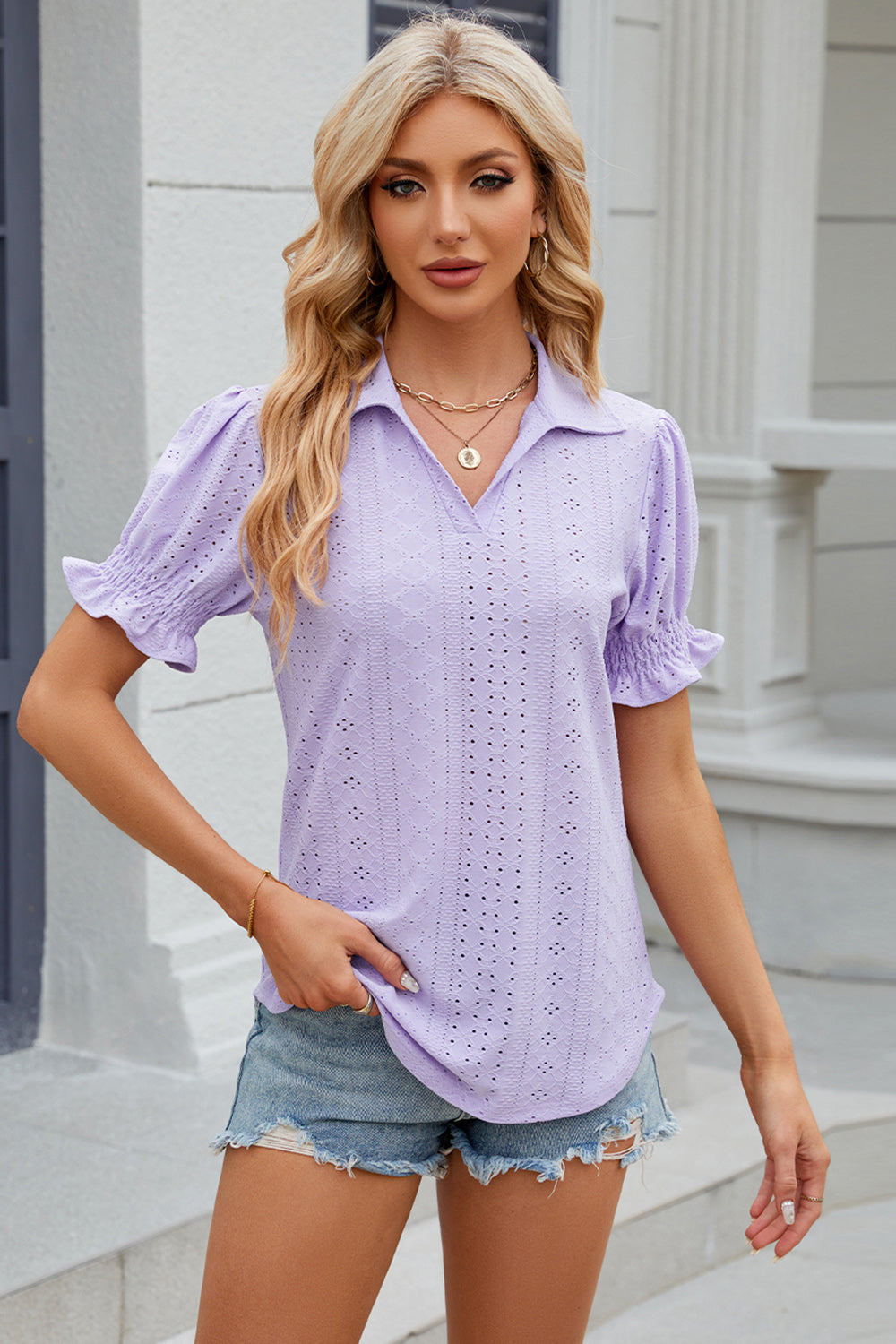 Lavender eyelet polo blouse with short puff sleeves and ruffled cuffs.