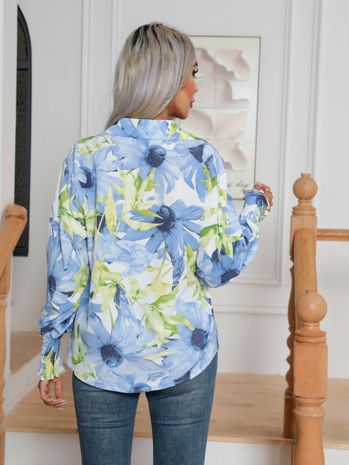 Blooms & Buttons shirt in light blue with a floral print and buttoned cuffs.