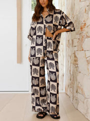 Black shell print silk pajama set with buttoned top and wide-leg pants