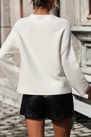 White ribbed mock neck sweater with volume sleeves and a relaxed fit.
