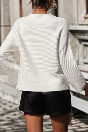 White ribbed mock neck sweater with volume sleeves and a relaxed fit.